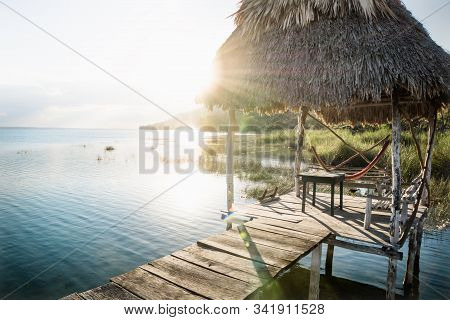 Dock During Sunset With Sun Rays Backlight At Lake Itza, El Remate, Peten, Guatemala
