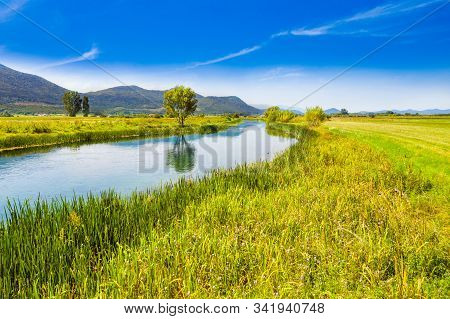 Croatia, Beautiful Scenic Landscape, Gacka River Among Grass Banks In Lika Region