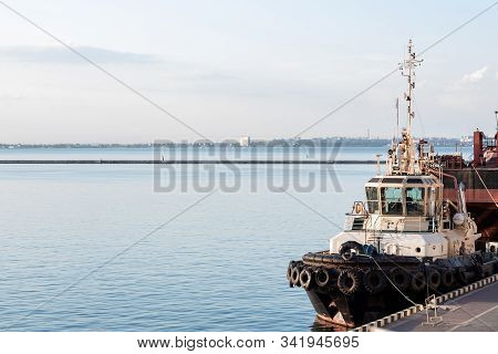 Colored Tugboat Works In Port. Bright Tugboat In Blue Water. Industrial Ship On Waves Tropical Islan