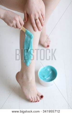 Beautiful Girl Cosmetitian With Blue Sugar Paste For Sugaring Depilation Close Up Photo With Bare Le