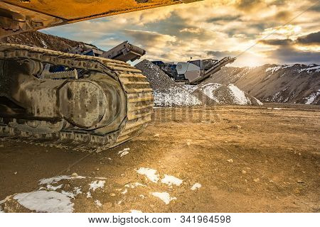 Stone Crusher And Excavator In An Open Pit Mine. Granite Mine To Make Gravel