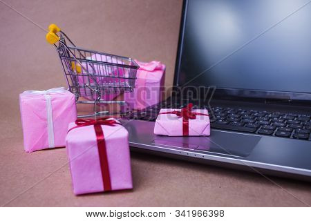 Buying Gifts On The Internet. Online Shopping, Sales And E-commerce. Shopping Cart With Gift Boxes. 