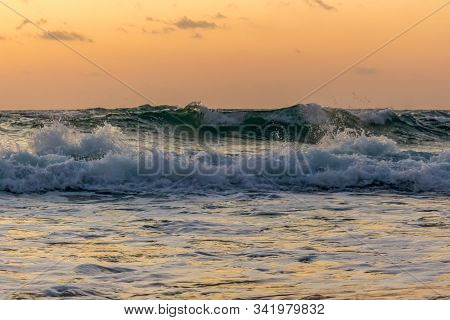 Waves Of Sea Tide At Dawn. Background In Warm Colors.