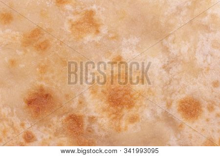 Background Texture Chapatti, Tortilla, Fried In Oil In A Pan. Top View, Close Up. Home Cooking Conce