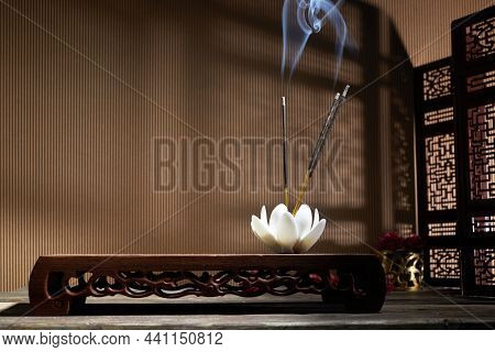 Smoke From Burning Incense Sticks Standing On Lotus Incense Holder