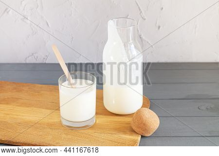 Vintage Jar With Cork Of Homemade Yogurt, Kefir, Fermented Milk Or Sour Cream Next To Drinking Glass