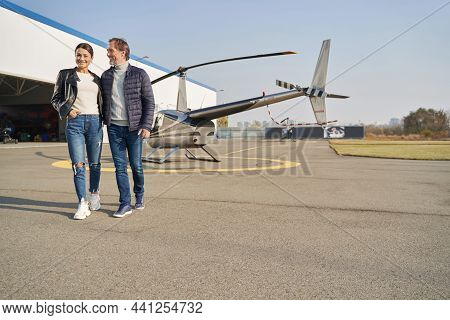 Charming Couple Taiking A Walk Through The Aerial Port