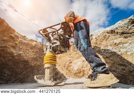 Worker Uses A Portable Vibration Rammer At Construction Of A Power Transmission Substation