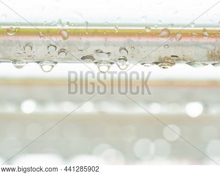 Morning Rain Drops On Tubular Stainless Steel Handrail In Detail