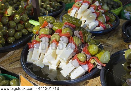 Skewered Appetizers Or Spanish Banderillas. Delicious Brochettes Filled With Anchovies And Tender Ch