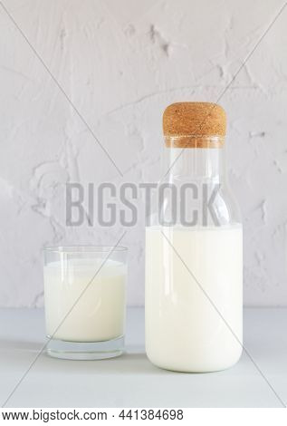 Vintage Jar Of Homemade Yogurt, Kefir, Fermented Milk Or Sour Cream Next To Drinking Glass On Kitche