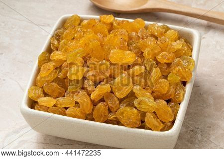 Bowl with sweet golden Sultana raisins close up