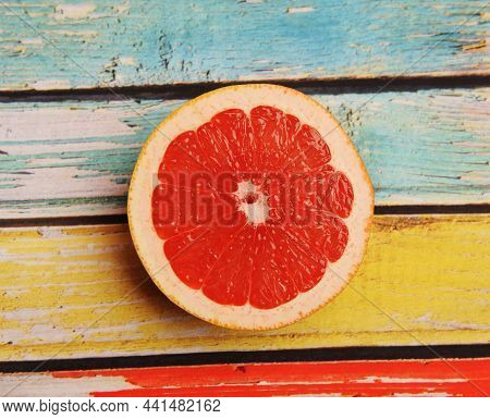 Half Grapefruit On A Colored Wooden Background, Top View