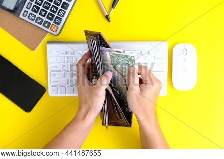 Concept Of Unrecognisable Businessman Using A Laptop While Working Remotely, Caculator And Notebook 