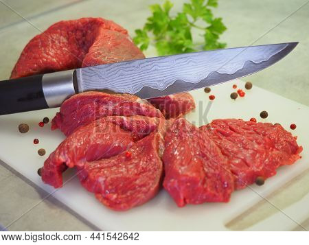A Damask Steel Knife With A Pattern Cuts Red Meat. Chopped Beef, Slices, Abolition Of Vegetarianism,