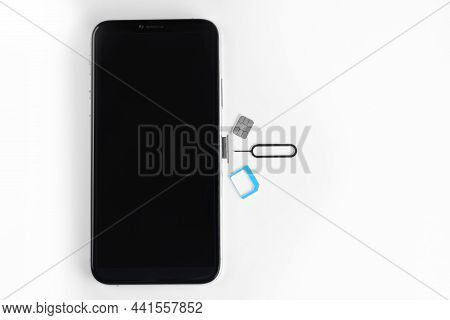 Sim Card, Mobile Phone And Ejector On White Table, Flat Lay