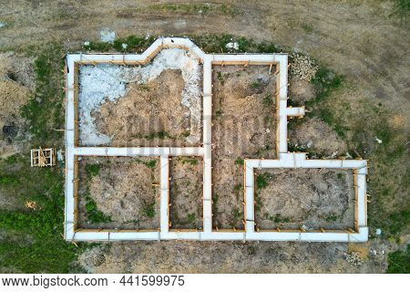 Top Down Aerial View Of Building Works Of New House Concrete Foundation On Construction Site.