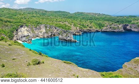 Aerial View By Drone Overlooking The Sea. Rocky Coast With High Cliffs, Beach With Hole On The Cliff
