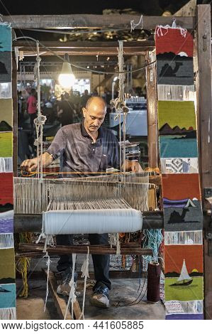 Sharm El Sheikh, Egypt - October 15, 2021: Middle Aged Man On Night Street Spinning Colorful Small R
