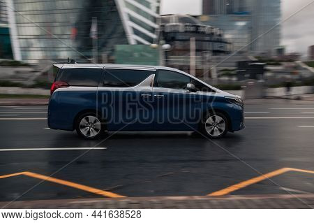 Toyota Alphard Executive Lounge Car Rides On Wet Slippery Asphalt Road. Fast Moving Minivan On The S