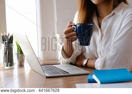 Closeup Hand Of Young Woman Working Laptop Computer On Internet Online On Desk At Home.