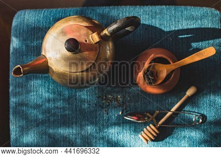 View Of A Table With An Old Bronze Teapot, A Ceramic Teapot With Tea And Other Tea Accessories. Cont
