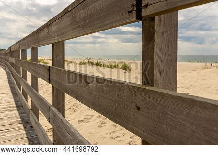 Wooden Platform With Railings On The Seashore. A Path Along The Beach Along The Sea. Wooden Handrail