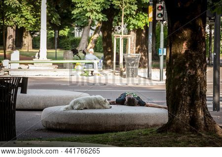 Ljubljana, Slovenia - June 15, 2021: Selective Blur On A Middle Adged Man Lying Down, Sleeping In A 