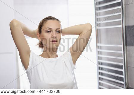 Portrait Of Young Woman Looking In Mirror At Herself In Bathroom, Pretending Shes Beautiful, Morning