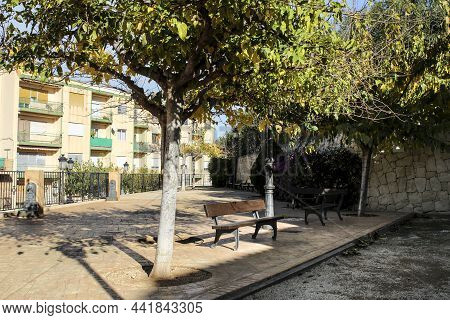 Little Garden With Benches And Trees In The Historical Town Of Polop In Alicante, Spain