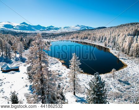 Kidelu Lake In Altai Mountains, Siberia, Russia. Snow-covered Trees And Mountains. Aerial Drone View