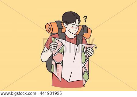 Confused Man Backpacker Hold Map Tracking Route Get Lost In Wilderness Nature Or Forest. Frustrated 