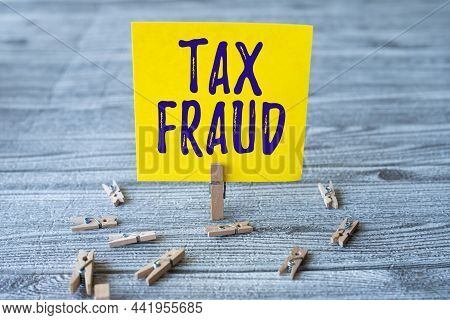 Handwriting Text Tax Fraud. Business Concept Entails Cheating On A Tax Return In An Attempt To Avoid
