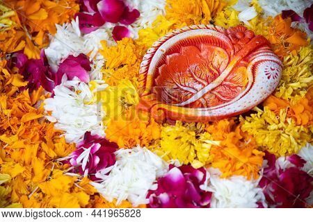 Close Up Shot Of Flower Petal Rangoli With Handmade Painted Petal Shaped Earthenware Diya Lamp Used 