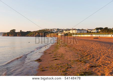 Goodrington beach near Paignton Devon England with colourful beach huts on a summer morning