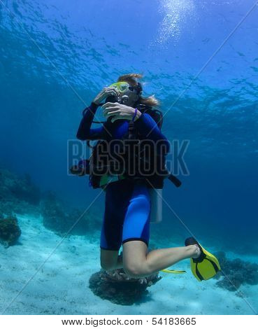 Scuba diver trying to equalize presure on the depth