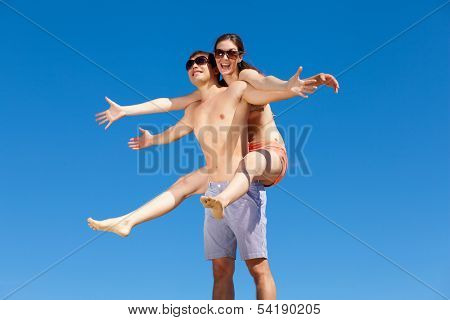 Portrait of a happy young couple enjoying at beach