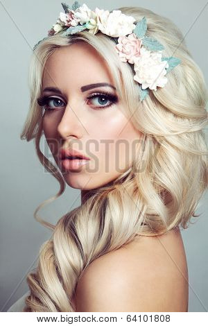 Beautiful girl with a wreath of flowers