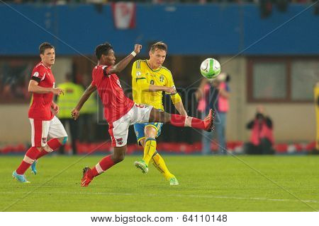 VIENNA,  AUSTRIA - JUNE  7 David Alaba (#8 Austria), and Kim Kaellstroem (#9 Sweden) fight for the ball during the world cup qualifier game on June 7, 2013 in Vienna, Austria.