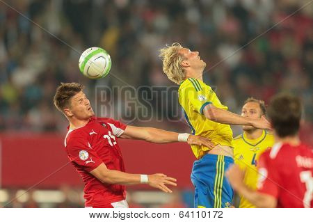 VIENNA,  AUSTRIA - JUNE  7 Ola Toivonen (#20 Sweden) and Sebastian Proedl (#15 Austria) fight for the ball during the world cup qualifier game on June 7, 2013 in Vienna, Austria.