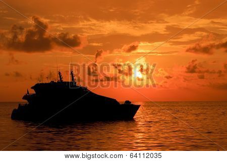 Large Luxury Yacht silhouette at sunset on ocean