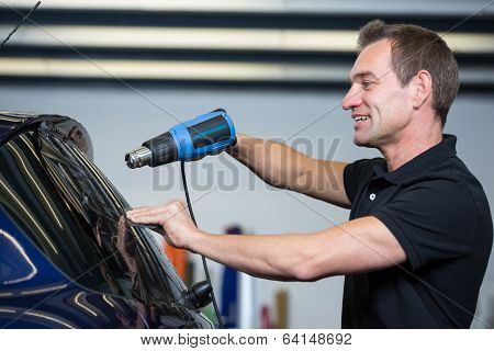 Car Wrapper Using Heat Gun And Squegee For Tinting Window