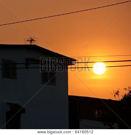 Sunset Behind The Building The Orange Light Across The Sky