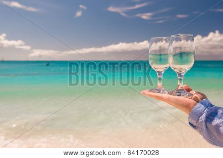Two clean glasses on background of sea