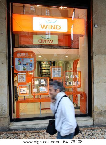 BOLOGNA, ITALY - APRIL 19, 2014: Pedestrians walk past a Wind Telecomunicazioni SpA mobile telephone store in Bologna, Italy, on Saturday, April 19, 2014. 