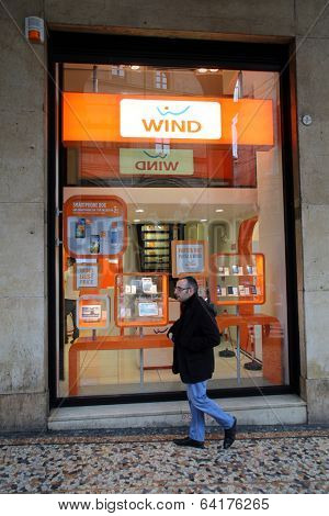 BOLOGNA, ITALY - APRIL 19, 2014: Pedestrians walk past a Wind Telecomunicazioni SpA mobile telephone store in Bologna, Italy, on Saturday, April 19, 2014. 
