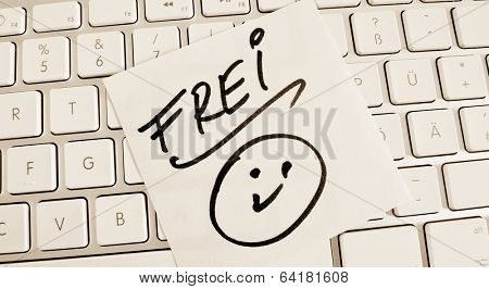 a sticky note is on the keyboard of a computer as a reminder: free