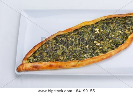Homemade traditional Turkish meal pide stuffed with meat cheese,  and sauce isolated on white background