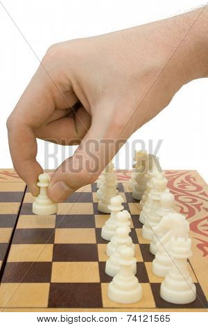 Pawn in hand and chessboard, isolated on white background