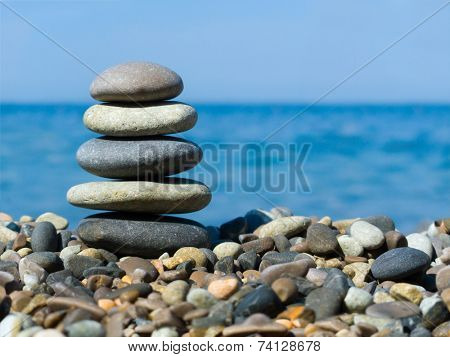 Stack of stones on beach, sea and sky